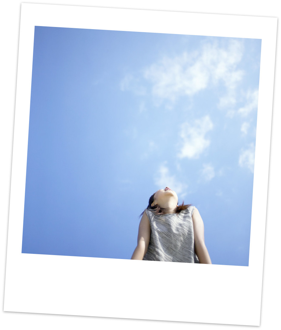 Photo of woman looking happy, looking up at sky